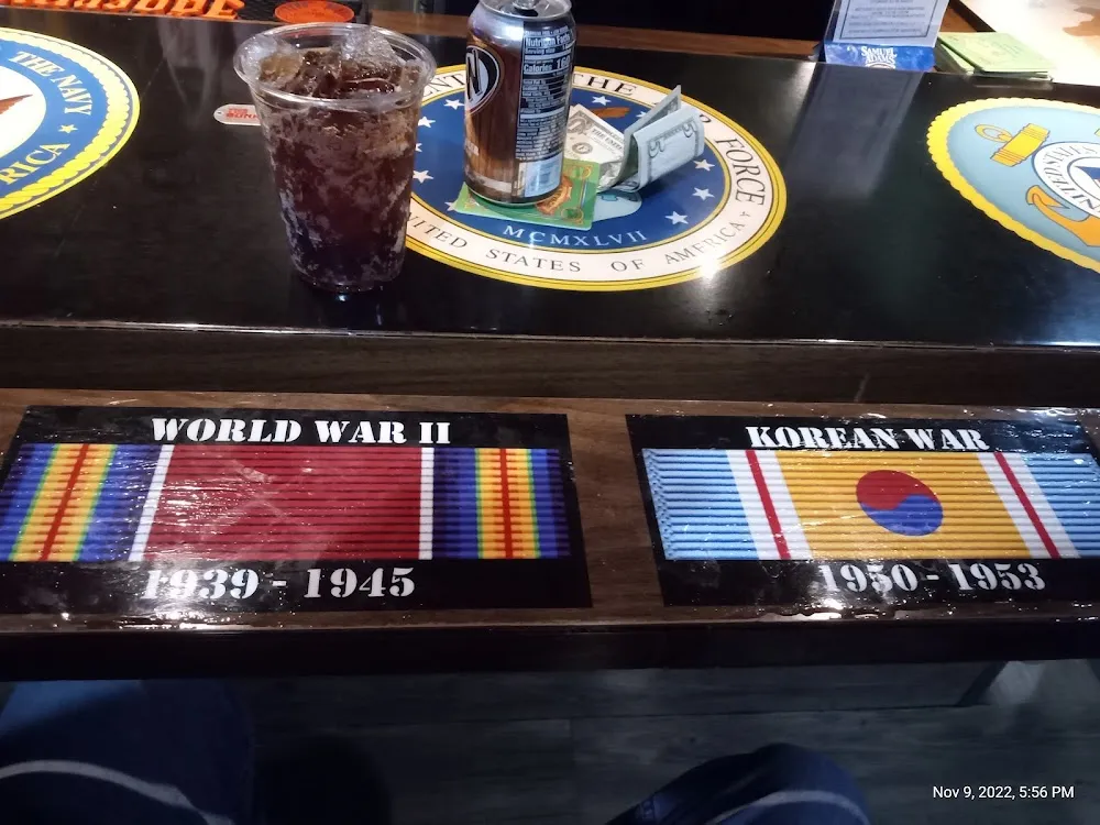 A Glass of a & w Root Beer at the Bar Which Is Very Cool Designed with Pictures of the War Ribbons